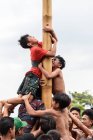KABUL BULELENG, BALI, INDONÉSIA - 17 de AGOSTO de 2015: Adolescentes de aldeia subindo em poste de madeira untada — Fotografia de Stock