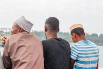 Tanzania, Zanzibar, Pemba Island, three African men from behind — Stock Photo