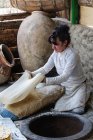 Armenia, Kotayk Province, Garni, Lavash is the typical Armenian bread. A wafer-thin dough is glued to the inside of a wood-fired stone oven. The parallels to the Indian Tandoor are obvious — Stock Photo
