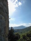 SARDINIA, ITALY - OCTOBER 20, 2013: Climber on rock in backlight — Stock Photo