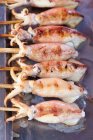 Close up shot of Grilled Squids on sticks, Kep Crab Market — Stock Photo