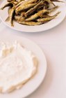 Fish and sheep cream cheese on table — Stock Photo