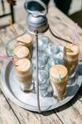 Sabroso café frappe y agua fría en vasos altos en verano caluroso durante el día en Kastro, Makedonia Thraki, Grecia . - foto de stock