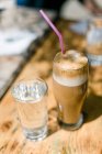 Tasty frappe coffee and cold water in high glasses in hot summer daytime at Kastro, Makedonia Thraki, Greece. — Stock Photo