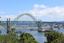 USA, Oregon, Rockaway Beach, view of ship sailing by a bridge — Stock Photo