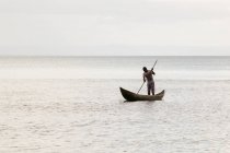 Vista del pescador de pie en barco, Madagascar - foto de stock
