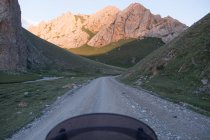 Kyrgyzstan, Naryn region, At-Bashi District, motorcycle on the dirt mountain road, Tash Rabat — Stock Photo