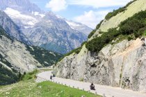 Switzerland, Valais, Obergoms VS, The Furka Pass with motorcyclists on mountain road — Stock Photo