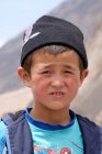 Portrait of rural boy looking at camera at street, Tajikistan — Stock Photo