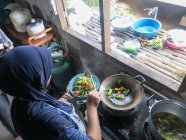 Thailand, Tambon Khuekkhak, top view of woman cooking in homestay — Stock Photo