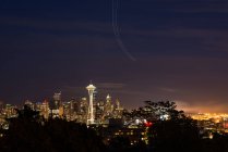 USA, Washington, Seattle, at night with a view of the Space Needle tower illuminated at night — Stock Photo