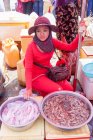 Cambodia, Kep, woman selling squid and shrimp at crabs market — Stock Photo
