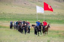 AK SAY, ISSYK-KUL REGION, KYRGYZSTAN - AUGUST 12, 2017: entry of athletes to the Nomad Games, local men riding horses — Stock Photo