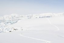 Antarctica, footprints in the snow and scenic frozen landscape in bright sunshine — Stock Photo