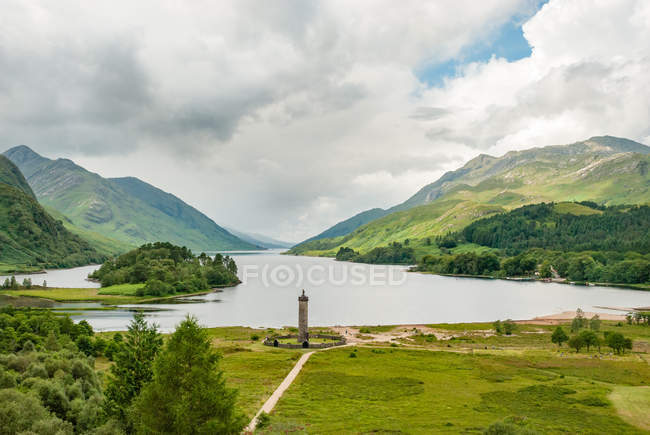 United Kingdom, Scotland, Highland, Glenfinnan, The Glenfinnan Monument from a distance, Glenfinnan is a small village in the Scottish Highlands, scenic mountains landscape with lake — Stock Photo