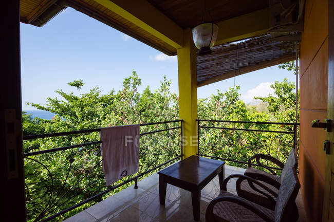 Indonesia, Maluku Utara, Kota Ternate, balcony between trees on volcanic island Gamalama on northern Molikken — Stock Photo