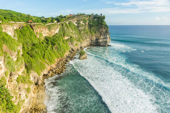 Индонезия, Бали, Кабудатен-Бадунг, крутая скальная стена у моря в храме Улувату — стоковое фото