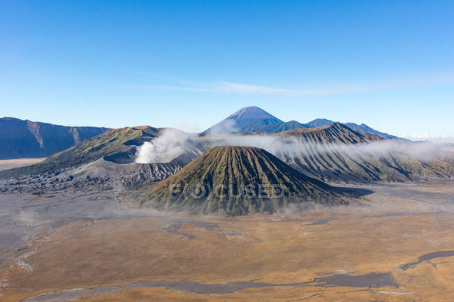 Indonesien, Java Timur, Probolinggo, Bromo rauchender Krater mit Blick auf Batok, Vulkan Semeru im Hintergrund — Stockfoto