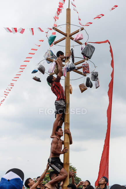 KABUL BULELENG, BALI, INDONÉSIA - 17 de AGOSTO de 2015: Adolescentes de aldeia subindo em poste de madeira untada — Fotografia de Stock