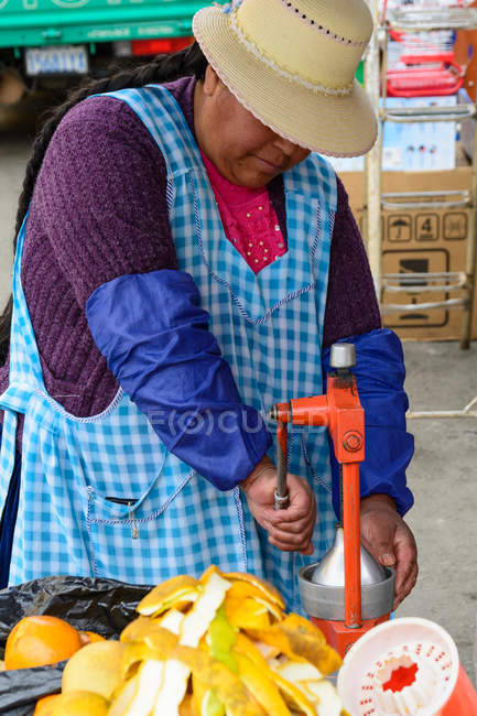 Venditore femminile che prepara succo fresco al mercato di strada a La Paz, Departamento de La Paz, Bolivia — Foto stock