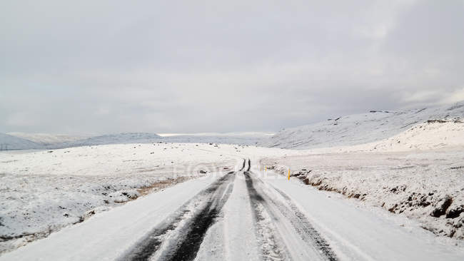 Perspektivisch schwindende Sicht auf verschneite Straße, Island — Stockfoto