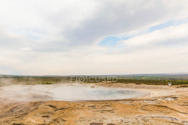 Geothermal pool with steam and camping car in distant, Iceland — Stock Photo