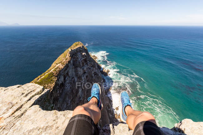 South Africa, Western Cape, Cape Town, Male feet over Cape of Good Hope scenic costal seascape in sunshine seeing from personal perspective — Stock Photo