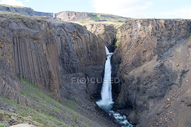 Scenic view of Litlanesfoss flowing from rocks — Stock Photo