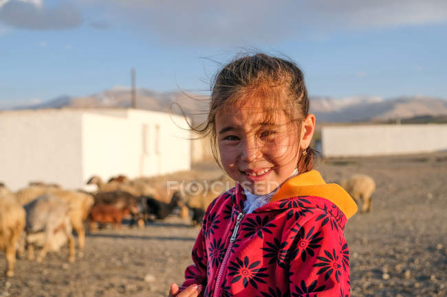 Asian girl smiling waving by hand at camera, Tajikistan — Stock Photo