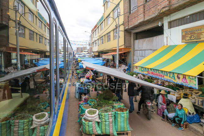 View from train passing through street market of Juliaca, Puno, Peru — Stock Photo