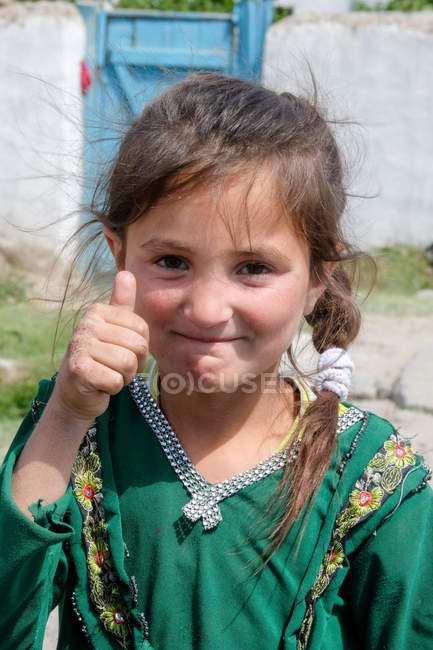 Portrait of girl in green national clothes Tajikistan — Stock Photo