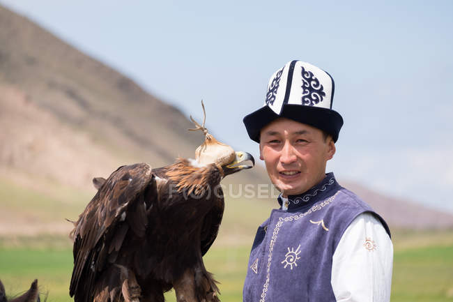 Cazador de águilas con águila real, Ak Say, región de Issyk-Kul, Kirguistán - foto de stock