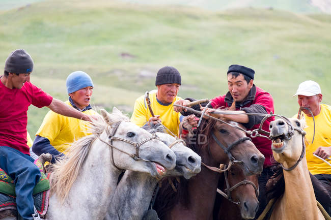 OSH REGION, KYRGYZSTAN - JULY 22, 2017: Nomadgames, local men riding on horses, participants in goat polo — Stock Photo