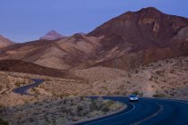 Car driving on arid highway by Lake Mead, Nevada, USA — Stock Photo