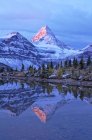 Mount Assiniboine reflected in pond at dawn, Mount Assiniboine Provincial Park, Canada — Stock Photo