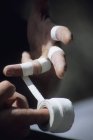 Close-up of climber taping hands with tape — Stock Photo