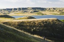 Randonneur dans le paysage du parc provincial Saskatchewan Landing avec le lac Diefenbaker en Saskatchewan, Canada — Photo de stock