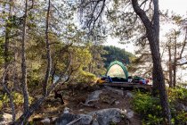 Tenda e pertences em West Curme Island com vista para Mink Island em Desolation Sound Marine Park, British Columbia, Canadá . — Fotografia de Stock