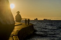 Silhouettes of couple strolling on Stanley Park seawall at sunset, Vancouver, British Columbia, Canada — Stock Photo