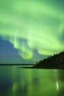 Aurora borealis over lake in boreal forest, Yellowknife environs, Northwest Territories, Canada — Stock Photo