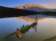 Canoe at Two Jack Lake at sunrise, Banff National Park, Alberta, Canada. — Stock Photo