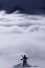 Person admiring mountains clouds at Kicking Horse Resort, Golden, British Columbia, Canada. — Stock Photo