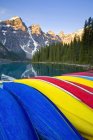 Colorful canoes stacked at Moraine Lake, Banff National Park, Alberta, Canada — Stock Photo