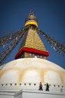 Low angle view of Boudhanath stupa with prayer flags at spiritual site in Kathmandu, Nepal. — Stock Photo