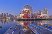 Telus World of Science reflecting in False Creek water with dragon boats, Vancouver, British Columbia, Canada — Stock Photo
