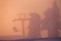Silhouettes of people riding chair lift at Cypress Mountain Resort, British Columbia, Canada. — Stock Photo
