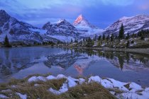 Mount Assiniboine reflected in pond at dawn, Mount Assiniboine Provincial Park, Canada — Stock Photo
