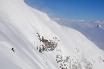 Male backcountry snowboarder riding steep face on Mount Cartier, Revelstoke, Canada — Stock Photo