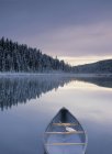 Canoe on Winchell Lake after first snowfall, Alberta, Canada. — Stock Photo