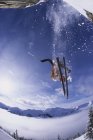 Skier catching air after jumping cliffs in backcountry of Kickinghorse Resort Area, Golden, British Columbia, Canada — Stock Photo